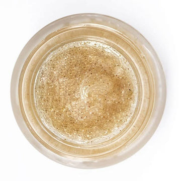 Gold glitter in a small clear container with 'INSIUM' branding on a white background
